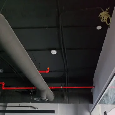 Red fire system pipes and ventilation ducts at a construction site